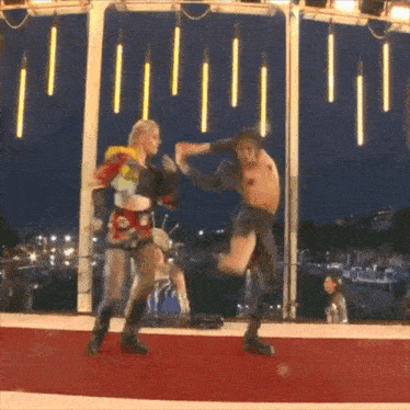 a couple of people are dancing on a red carpet
