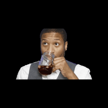 a man is drinking from a mason jar