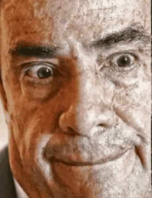 a close up of a man 's face with a funny face