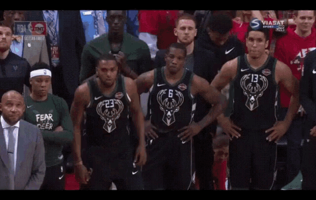 a group of basketball players with one wearing a fear deer sweatshirt