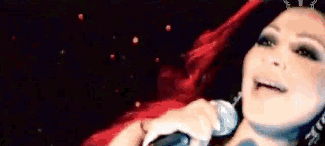 a close up of a woman 's face with a black background