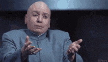 a bald man in a blue suit is pointing