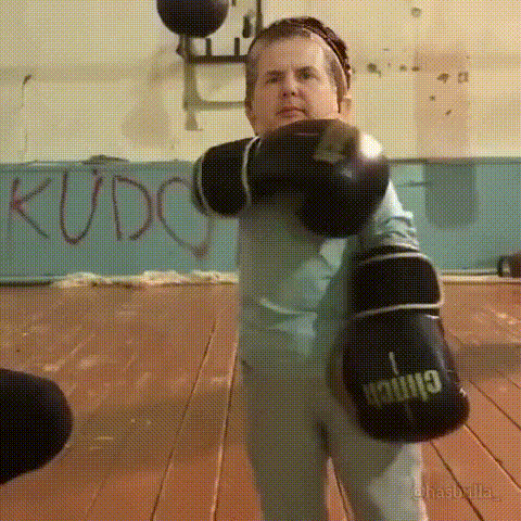 a man is wearing boxing gloves that say kudo on them .