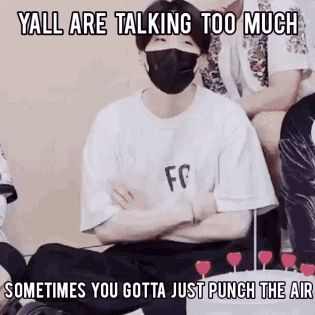 a man wearing a mask is sitting on the floor with his arms crossed and a meme that says yall are talking too much
