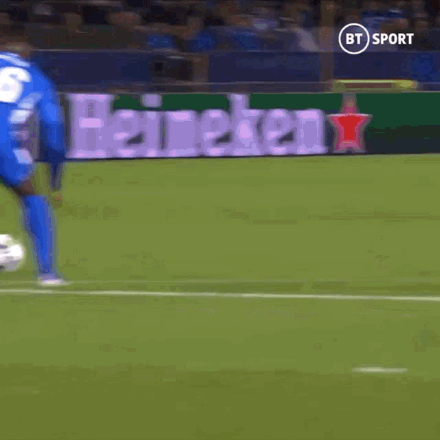 soccer players on a field with a bt sport logo in the corner