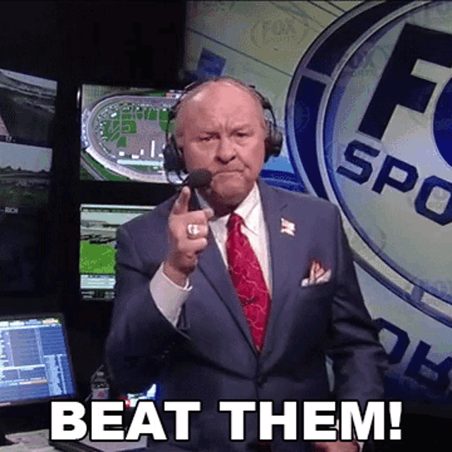a man in a suit and tie is pointing at the camera with the words beat them below him