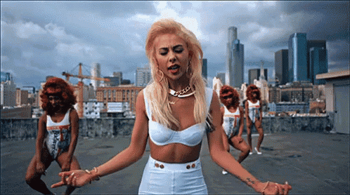 a woman in a white top and shorts is standing in front of a city