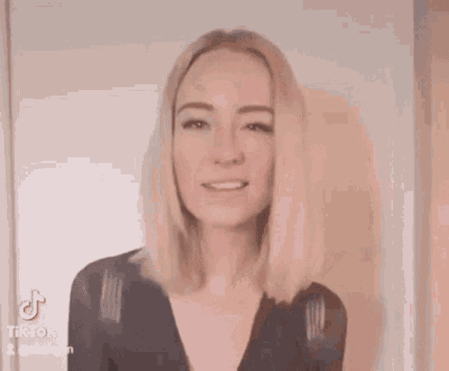 a woman is holding a fork in her hand and making a face .