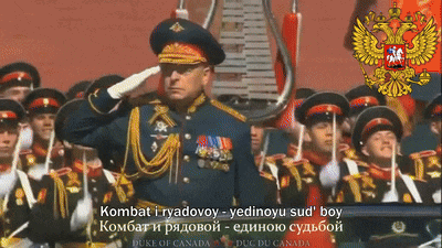 a man in a military uniform salutes in front of a russian flag