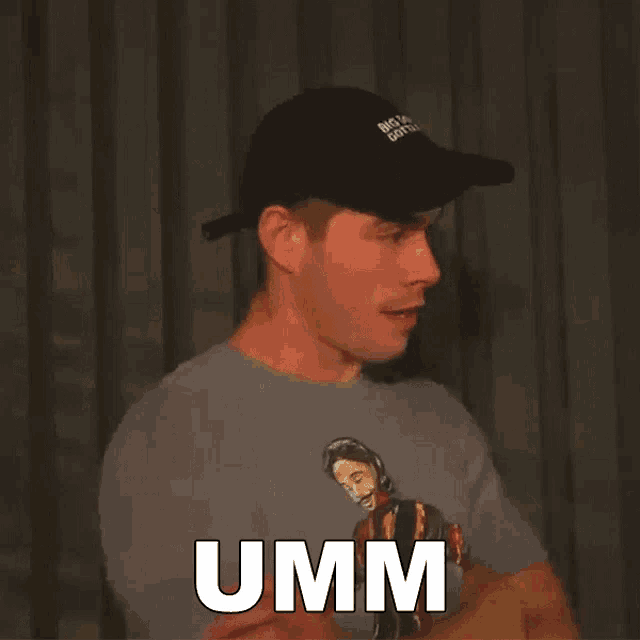 a man wearing a hat and a shirt that says umm