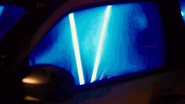 a blue light is shining through the window of a vehicle