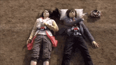 a man and a woman are laying on the ground with their heads on pillows .