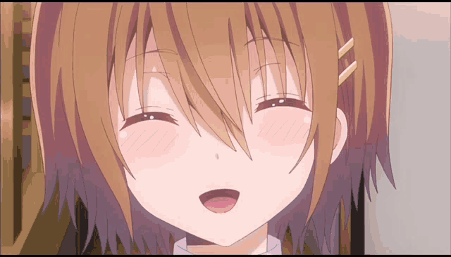 a girl with brown hair is smiling with her mouth open