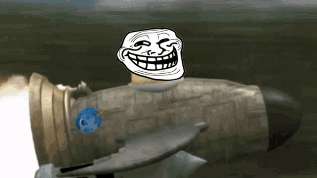 a troll face is sitting on top of a rocket with a blue object coming out of it