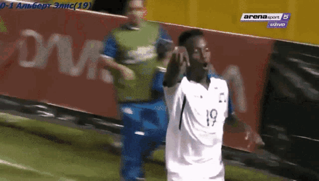 a soccer player wearing a white jersey with the number 19