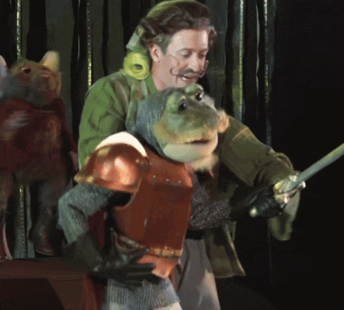 a man is holding a sword next to a stuffed animal