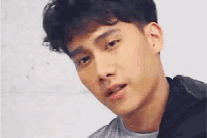 a close up of a young man 's face against a white background .