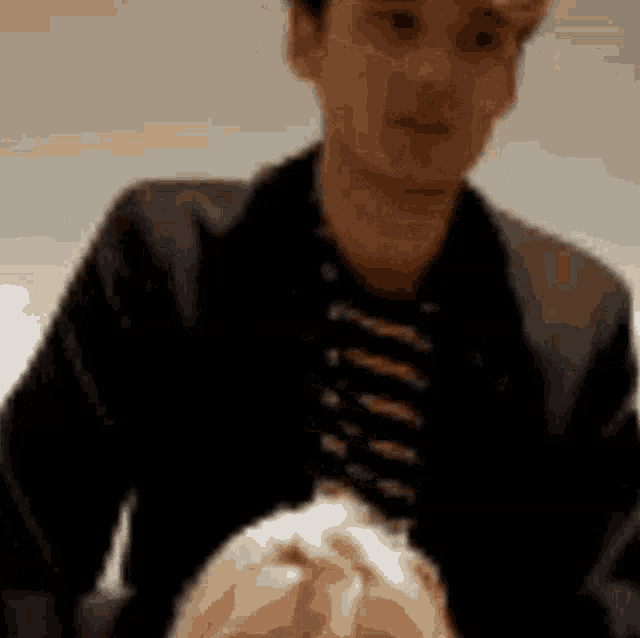 a man is holding a woman 's head in a blurry photo .