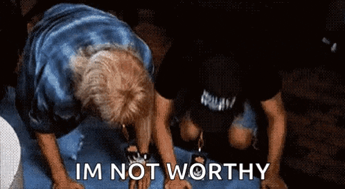 two men are kneeling down and one of them is saying i 'm not worthy .