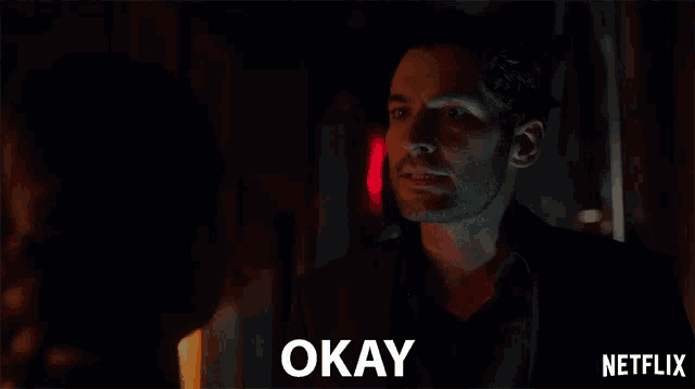 a man in a suit says okay next to a woman