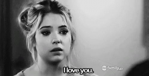 a black and white photo of a woman crying and saying i love you .