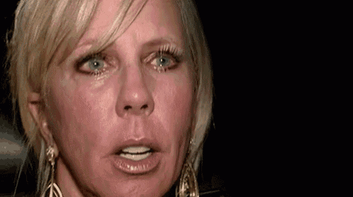 a close up of a woman with tears running down her face .