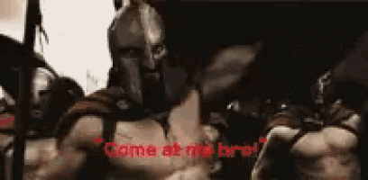 a man in a spartan helmet is giving a middle finger and says `` come at me bro '' .
