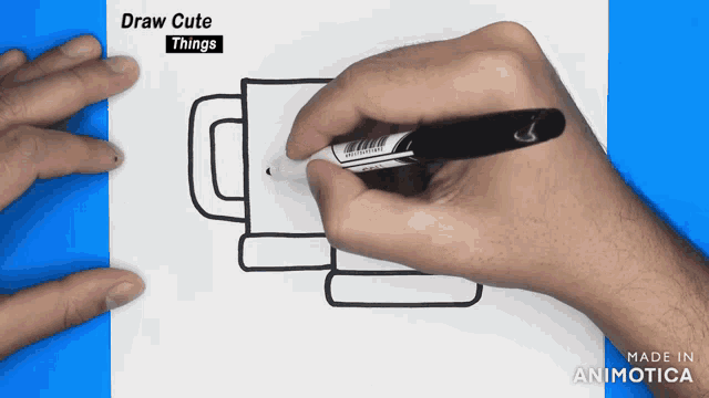 a person is drawing a cup with a marker and the words draw cute things are above them