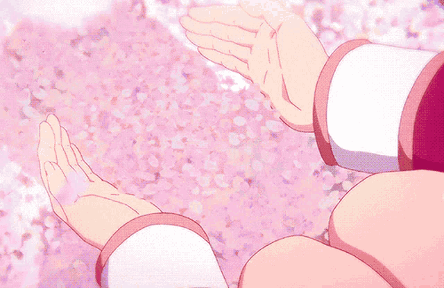 a person 's hands are reaching out towards a pink background of flowers