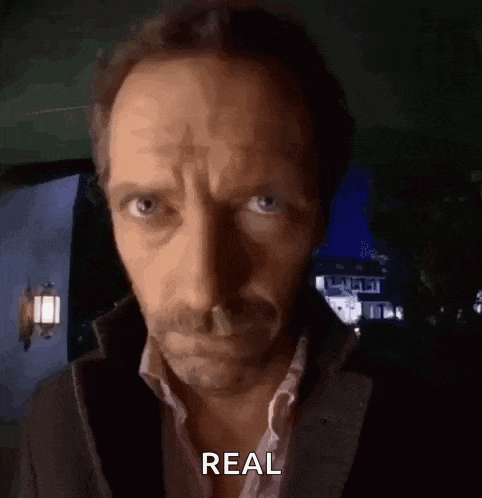 a close up of a man 's face with the word real above it