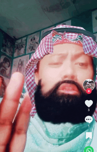 a man with a beard is wearing a head scarf and a bandana