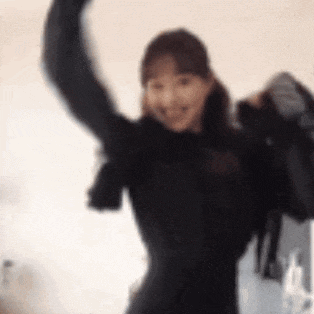 a blurry picture of a woman holding her arms in the air