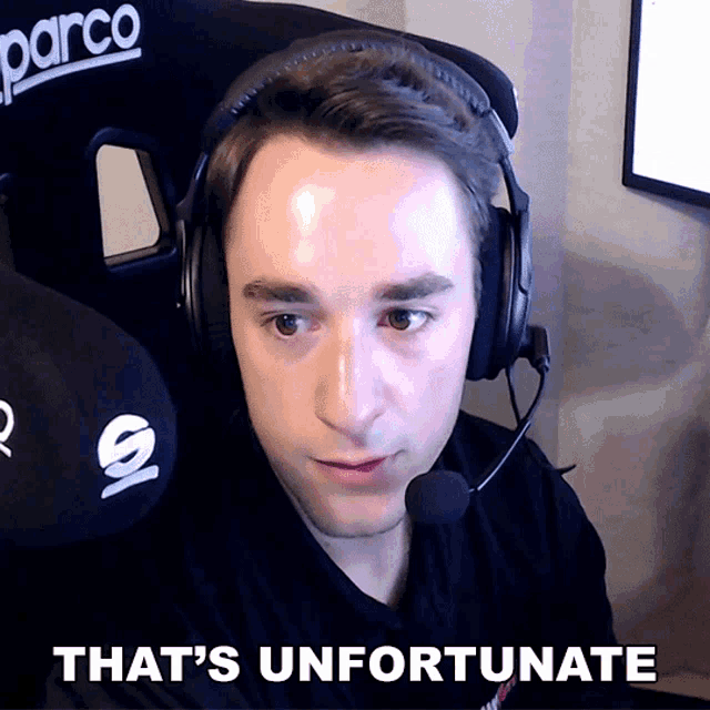a man wearing headphones and a microphone with the words that 's unfortunate above him