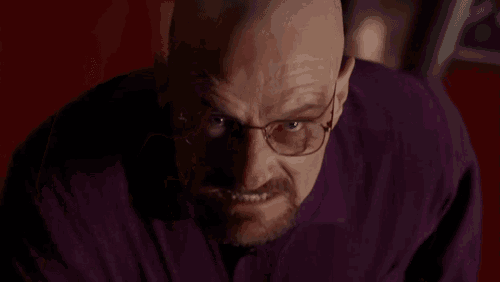a man with glasses and a beard is giving the middle finger to the camera .
