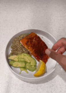 a plate of food with salmon avocado and rice