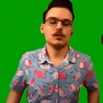 a man with a mustache and glasses is wearing a shirt with mice on it .