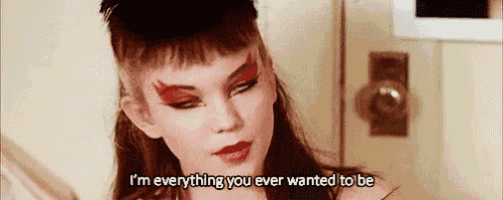 a woman with red makeup on her face is talking about everything she ever wanted to be .