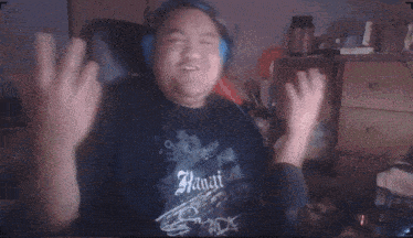 a man wearing headphones is wearing a shirt that says hawaii