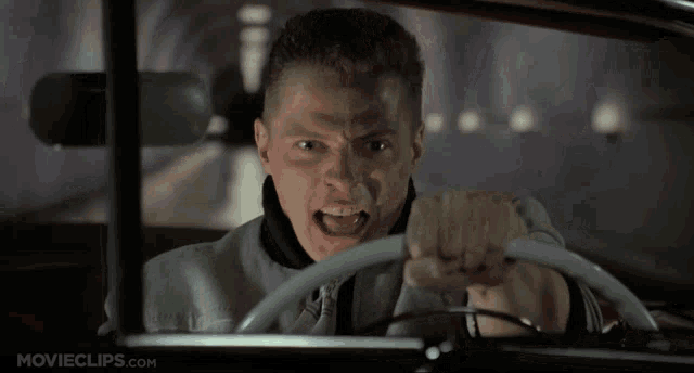 a man in a car with movieclips.com on the bottom right