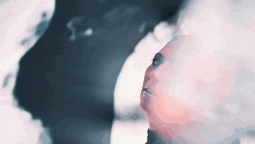 a close up of a person 's face with a shadow of a person behind them