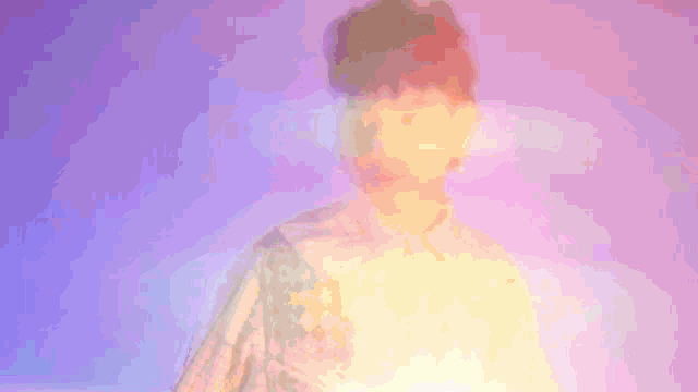 a blurry picture of a person with a pink background
