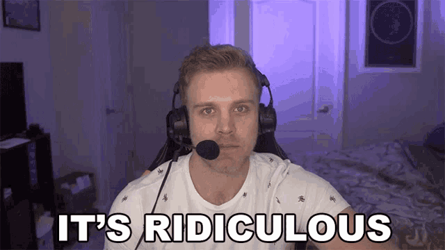 a man wearing headphones says it 's ridiculous in front of a bed