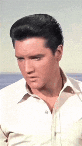 a close up of elvis presley 's face with a white shirt on