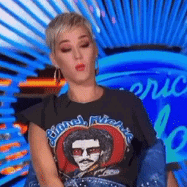 a woman wearing a black shirt with a picture of a man on it .