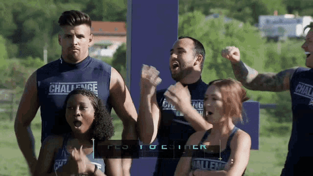 a group of people wearing challenge shirts are standing in a field