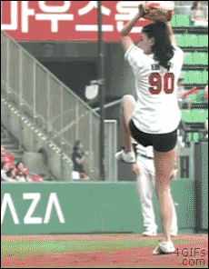 a woman with the number 90 on her jersey is throwing a baseball