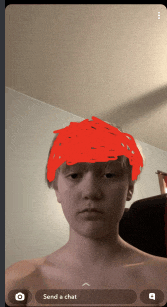 a screenshot of a boy with a red head and the words send a chat at the bottom
