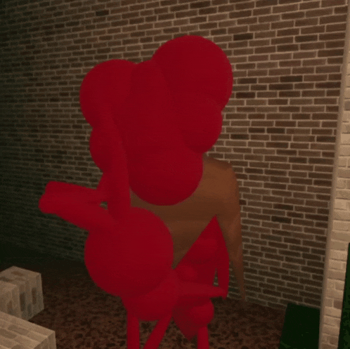 a red object against a brick wall in a room
