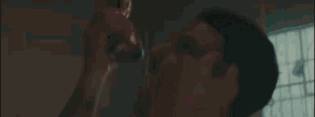 a drummer is playing drums in a dark room .