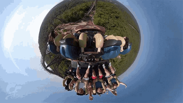 a group of people are riding a roller coaster and the letters cf are on the bottom right corner